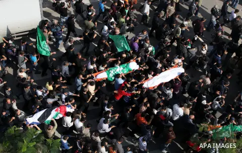 Palestinians carry the bodies of the al-Dallu family during their funeral in Gaza City, 19 November 2012. Nine members of the al-Dallu family died when Israeli forced hit their building in Gaza City one day ago. Media re...