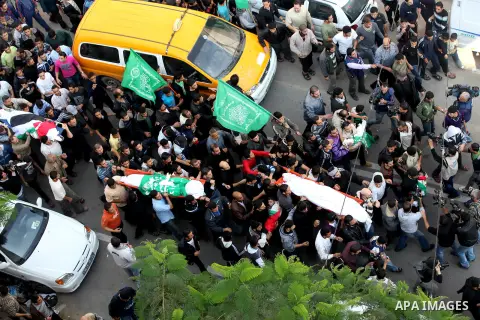 Palestinians carry the bodies of the al-Dallu family during their funeral in Gaza City, 19 November 2012. Nine members of the al-Dallu family died when Israeli forced hit their building in Gaza City one day ago. Media re...