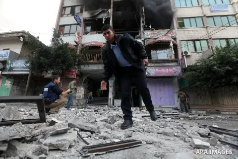 Palestinians inspect the damage after an Israeli air strike on al-Shorooq building in Gaza city, 19 November, 2012. Media reports that Israeli forces were on Monday targeting the Palestinian homes and other buildings in...