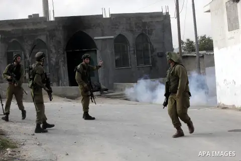 Israeli soldiers fire tear gas at Palestinian protesters during protest against burning mosques in the West Bank city of Nablus, 19 November 2012. Jewish settlers Monday set fire to al-Ribat mosque in Orif village, burni...