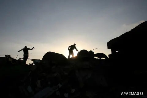 Palestinians inspect the damage after an Israeli air strike in Rafah in southern Gaza strip, 19 November, 2012. Media reports that Israeli forces were on Monday targeting the Palestinian homes and other buildings in its...