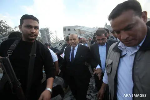 The leader of Egypt's Islamist Freedom and Justice Party Saad al-Katatni walks on rubbles of destroyed Palestinian Cabinet during his visit to gaza strip, in Gaza city, Nov. 19, 2012. APAimages \ Yasser Qudih, POOL