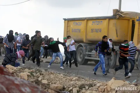 Palestinian protesters throw stones at Israeli security forces during minor clashes against Israel's military operation in the Gaza Strip, in the West Bank village of Birzeit, near Ramallah November 19, 2012. Israel bomb...