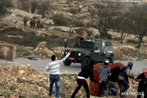 Palestinian protesters throw stones at Israeli security forces during minor clashes against Israel's military operation in the Gaza Strip, in the West Bank village of Birzeit, near Ramallah November 19, 2012. Israel bomb...