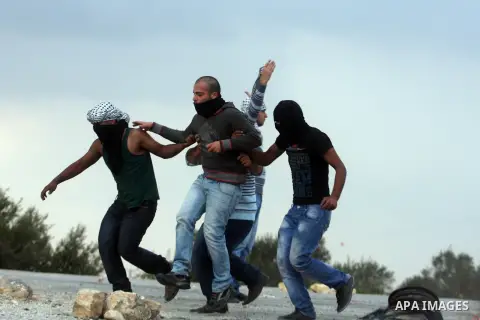 Palestinians carry a wounded man during minor clashes against Israel's military operation in the Gaza Strip, in the West Bank village of Birzeit, near Ramallah November 19, 2012. Israel bombed dozens of targets in Gaza o...