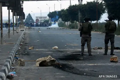 Palestinian protesters throw stones at Israeli soldiers during clashes against Israel's military operation in the Gaza Strip, in the West Bank city of Nablus on November 19, 2012. Israeli air strikes killed 22 Palestinia...
