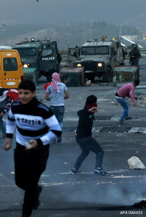 Palestinian protesters throw stones at Israeli soldiers during clashes against Israel's military operation in the Gaza Strip, in the West Bank city of Nablus on November 19, 2012. Israeli air strikes killed 22 Palestinia...