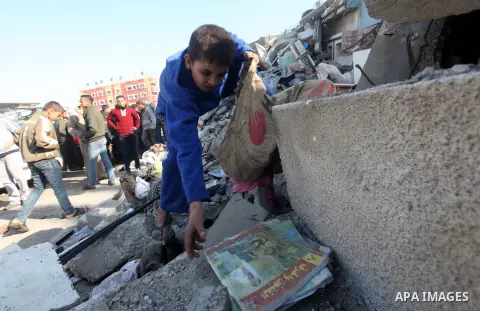 A Palestinian boy salvages his books from a building destroyed by an Israeli airstrike, in Gaza City, Gaza Strip, 20 November 2012. Media reports that Israel pounded more than 100 targets in Gaza on the seventh day of it...