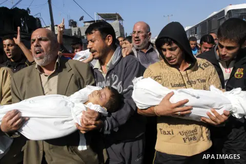 Palestinians carry the bodies of brothers Suhaib, 2-years-old, and Mohammed Hejazi, 4-years-old, during their funeral in the northern Gaza Strip area of Biet Lahia, on November 20, 2012. Four members of the Hejazi family...