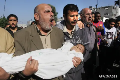 Palestinians carry the bodies of brothers Suhaib, 2-years-old, and Mohammed Hejazi, 4-years-old, during their funeral in the northern Gaza Strip area of Biet Lahia, on November 20, 2012. Four members of the Hejazi family...