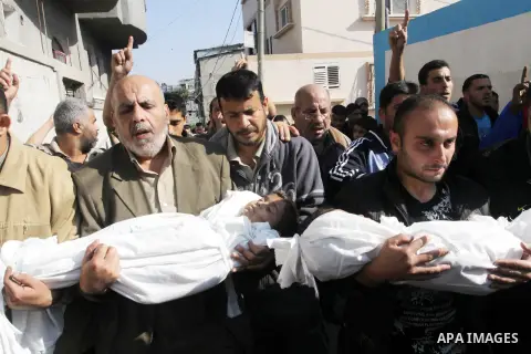 Palestinians carry the bodies of brothers Suhaib, 2-years-old, and Mohammed Hejazi, 4-years-old, during their funeral in the northern Gaza Strip area of Biet Lahia, on November 20, 2012. Four members of the Hejazi family...
