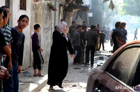Palestinians get out of their houses after Israeli aircraft threatened to target the area, in the Jebaliya refugee camp, in Gaza Strip, Tuesday, Nov. 20, 2012. Palestinian families are fleeing their homes destroyed by ai...