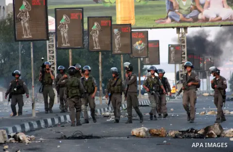 Israeli border policemen fire tear gas at Palestinian protesters during clashes in the West Bank city of Nablus, on November 20, 2012. The West Bank has witnessed almost daily demonstrations in support of Gaza Palestinia...