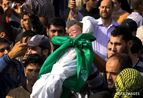 Palestinians carry the bodies of brothers Suhaib, 2-years-old, and Mohammed Hejazi, 4-years-old, during their funeral in the northern Gaza Strip area of Biet Lahia, on November 20, 2012. Four members of the Hejazi family...