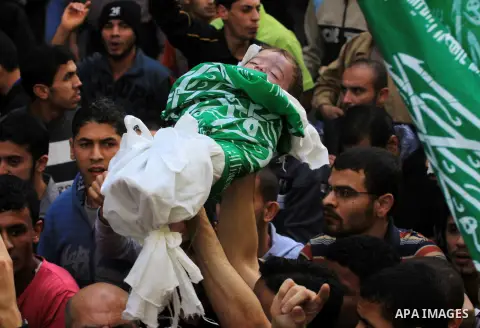 Palestinians carry the bodies of brothers Suhaib, 2-years-old, and Mohammed Hejazi, 4-years-old, during their funeral in the northern Gaza Strip area of Biet Lahia, on November 20, 2012. Four members of the Hejazi family...