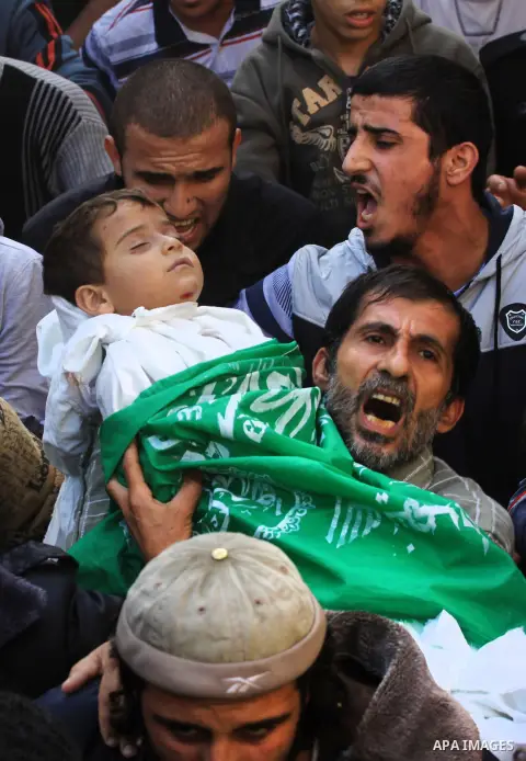 Palestinians carry the bodies of brothers Suhaib, 2-years-old, and Mohammed Hejazi, 4-years-old, during their funeral in the northern Gaza Strip area of Biet Lahia, on November 20, 2012. Four members of the Hejazi family...