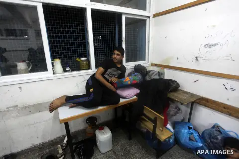 Displaced Palestinians from al-Atatra area, whose fled their house, gather in their temporary residence, at a United Nations-run school in Gaza City, on November 21, 2012. Israeli leaders discussed an Egyptian plan for a...