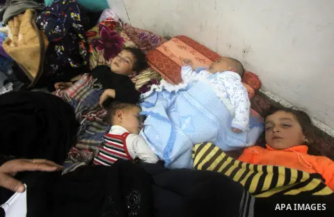 Displaced Palestinians from al-Atatra area, whose fled their house, gather in their temporary residence, at a United Nations-run school in Gaza City, on November 21, 2012. Israeli leaders discussed an Egyptian plan for a...