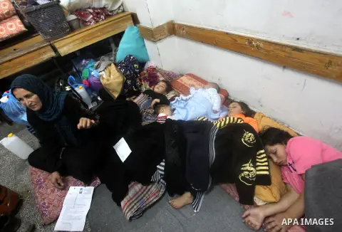 Displaced Palestinians from al-Atatra area, whose fled their house, gather in their temporary residence, at a United Nations-run school in Gaza City, on November 21, 2012. Israeli leaders discussed an Egyptian plan for a...