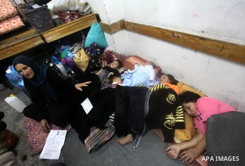 Displaced Palestinians from al-Atatra area, whose fled their house, gather in their temporary residence, at a United Nations-run school in Gaza City, on November 21, 2012. Israeli leaders discussed an Egyptian plan for a...