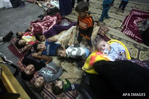 Displaced Palestinians from al-Atatra area, whose fled their house, gather in their temporary residence, at a United Nations-run school in Gaza City, on November 21, 2012. Israeli leaders discussed an Egyptian plan for a...