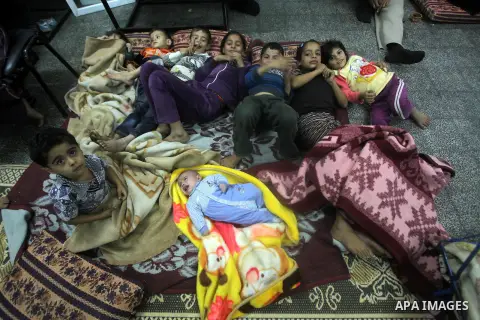 Displaced Palestinians from al-Atatra area, whose fled their house, gather in their temporary residence, at a United Nations-run school in Gaza City, on November 21, 2012. Israeli leaders discussed an Egyptian plan for a...