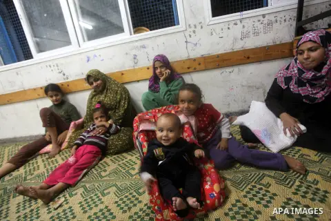Displaced Palestinians from al-Atatra area, whose fled their house, gather in their temporary residence, at a United Nations-run school in Gaza City, on November 21, 2012. Israeli leaders discussed an Egyptian plan for a...