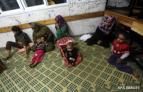 Displaced Palestinians from al-Atatra area, whose fled their house, gather in their temporary residence, at a United Nations-run school in Gaza City, on November 21, 2012. Israeli leaders discussed an Egyptian plan for a...