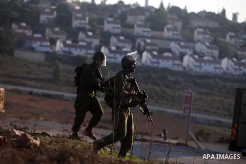 Israeli security forces shoot at Palestinian protesters during clashes in the West Bank village in Nabi Saleh, near Ramallah November 20, 2012. Two funeral processions for Palestinians killed during clashes with the Isra...