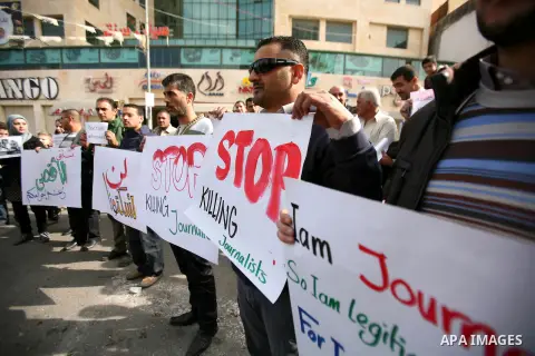 Palestinian Journalists hold placards during a protest against the Israeli targeting the Gazans media members, in the West Bank city of Hebron, November 21, 2012. Two cameramen from Hamas-owned Al-Aqsa TV were among six...