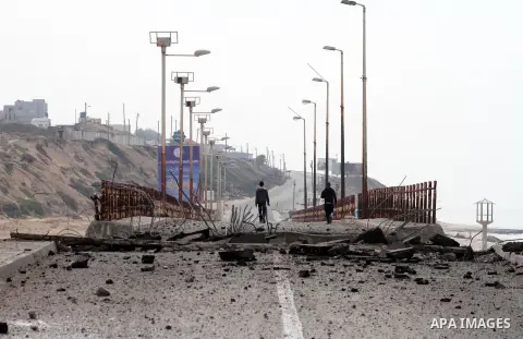 Palestinians look at Wadi Gaza bridge, a strategic link between the northern and southern areas of the Gaza Strip, following an overnight Israeli air strike on November 21, 2012. Today's bloodshed raised to 148 the total...