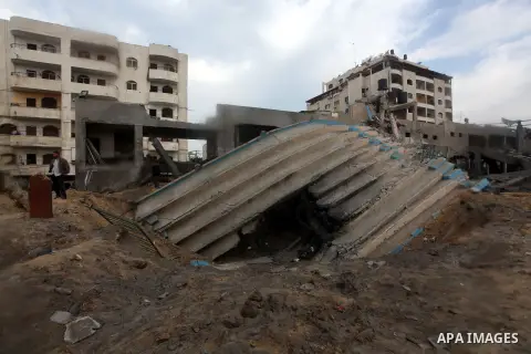 Palestinians inspect the debris of the destroyed Palestine Sports Stadium in Gaza City on November 22, 2012, after a ceasefire took hold in and around Gaza after a week of cross-border violence between Israel and Palesti...