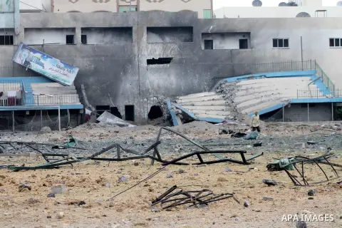 Palestinians inspect the debris of the destroyed Palestine Sports Stadium in Gaza City on November 22, 2012, after a ceasefire took hold in and around Gaza after a week of cross-border violence between Israel and Palesti...