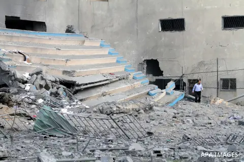 Palestinians inspect the debris of the destroyed Palestine Sports Stadium in Gaza City on November 22, 2012, after a ceasefire took hold in and around Gaza after a week of cross-border violence between Israel and Palesti...