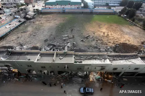 Palestinians inspect the debris of the destroyed Palestine Sports Stadium in Gaza City on November 22, 2012, after a ceasefire took hold in and around Gaza after a week of cross-border violence between Israel and Palesti...