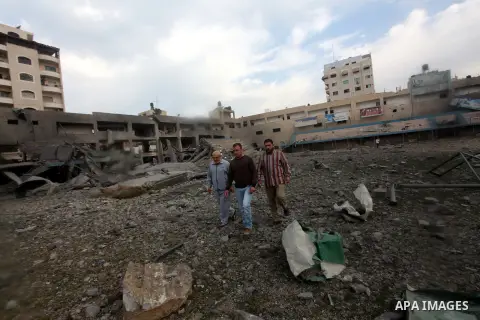 Palestinians inspect the debris of the destroyed Palestine Sports Stadium in Gaza City on November 22, 2012, after a ceasefire took hold in and around Gaza after a week of cross-border violence between Israel and Palesti...