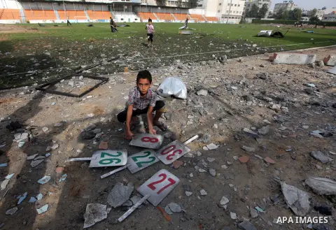 Palestinians inspect the debris of the destroyed Yarmouk Sports Stadium in Gaza City on November 22, 2012, after a ceasefire took hold in and around Gaza after a week of cross-border violence between Israel and Palestini...