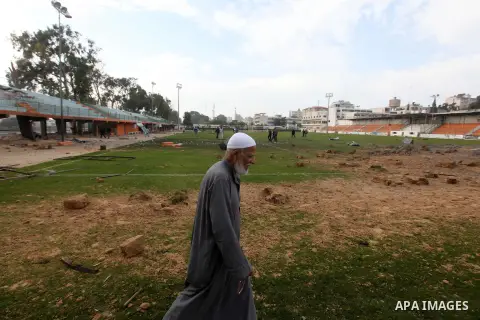 Palestinians inspect the debris of the destroyed Yarmouk Sports Stadium in Gaza City on November 22, 2012, after a ceasefire took hold in and around Gaza after a week of cross-border violence between Israel and Palestini...