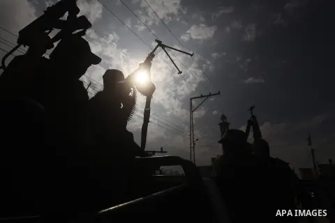 Hamas militants ride in a pick-up truck as they take part in the funeral of their comrades, whom medics said were killed in Israeli air strikes on Wednesday, in the central Gaza Strip November 22, 2012. A ceasefire betwe...