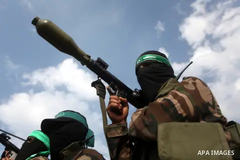 Hamas militants ride in a pick-up truck as they take part in the funeral of their comrades, whom medics said were killed in Israeli air strikes on Wednesday, in the central Gaza Strip November 22, 2012. A ceasefire betwe...