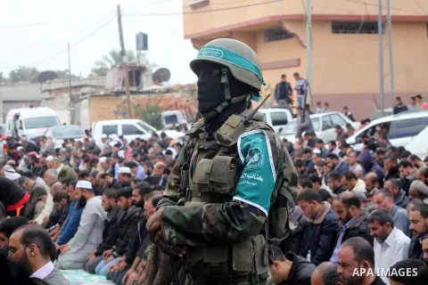 A Hamas militant prayer during the funeral for his fellow comrades, whom medics said were killed in Israeli air strikes on Wednesday, in the central Gaza Strip November 22, 2012. A ceasefire between Israel and Gaza's Ham...