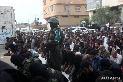 A Hamas militant prayer during the funeral for his fellow comrades, whom medics said were killed in Israeli air strikes on Wednesday, in the central Gaza Strip November 22, 2012. A ceasefire between Israel and Gaza's Ham...