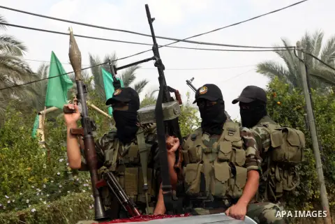 Hamas militants ride in a pick-up truck as they take part in the funeral of their comrades, whom medics said were killed in Israeli air strikes on Wednesday, in the central Gaza Strip November 22, 2012. A ceasefire betwe...