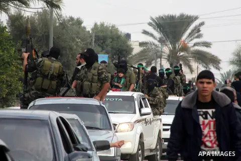Hamas militants ride in a pick-up truck as they take part in the funeral of their comrades, whom medics said were killed in Israeli air strikes on Wednesday, in the central Gaza Strip November 22, 2012. A ceasefire betwe...