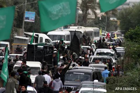 Hamas militants ride in a pick-up truck as they take part in the funeral of their comrades, whom medics said were killed in Israeli air strikes on Wednesday, in the central Gaza Strip November 22, 2012. A ceasefire betwe...