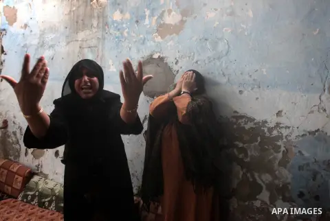 Relatives of three-year-old Reham Al Nabaheen mourn during her funeral in Al Nusairat refugee camp in the central Gaza Strip, 22 November 2012. Reham Al Nabaheen was reportedly killed after an Israeli air strike on Al Bu...