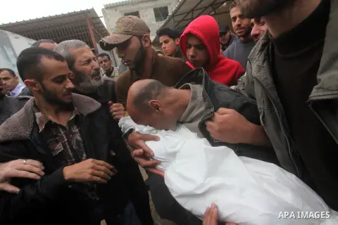 A man holds the body of his daughter, three-year-old Reham Al Nabaheen, during her funeral at Al Nusairat refugee camp in central Gaza Strip, 22 November 2012. Reham Al Nabaheen was reportedly killed after an Israeli air...