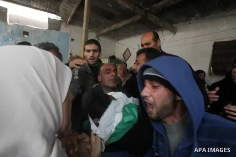 A man holds the body of his daughter, three-year-old Reham Al Nabaheen, during her funeral at Al Nusairat refugee camp in central Gaza Strip, 22 November 2012. Reham Al Nabaheen was reportedly killed after an Israeli air...