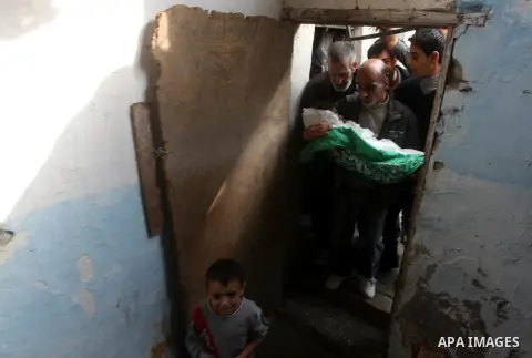 A man holds the body of his daughter, three-year-old Reham Al Nabaheen, during her funeral at Al Nusairat refugee camp in central Gaza Strip, 22 November 2012. Reham Al Nabaheen was reportedly killed after an Israeli air...