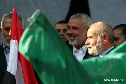 Palestinian prime minister in Gaza Ismail Haniyeh and Islamic Jihad leader Mohammed Al-Hindi, senior Fatah official Nabil Shaath and deputy speaker of Palestinian Parliament Ahmed Bahar celebrate what Palestinians say is...